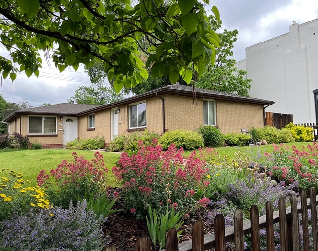View of 2244 (right half of duplex) with flower beds and front yard, all on a quiet streetpluex - 2244 N Franklin St