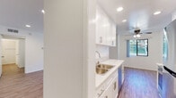 Located in the desirable community of Westlake Village, California, this single-floor residence offers a clean, modern aesthetic throughout. Wood-style plank flooring flows consistently across the living areas, bedrooms, and kitchen, creating a cohesive and contemporary feel.

The open living and dining area is bright and airy, featuring recessed lighting, a ceiling fan, and large sliding glass doors that lead to a private patio, allowing natural light to fill the space and providing a seamless indoor-outdoor connection.

The galley-style kitchen is well-appointed with crisp white shaker cabinetry, light quartz countertops, stainless steel appliances including a range, microwave, refrigerator, and dishwasher, as well as a double-basin sink. Recessed lighting illuminates the full length of the kitchen efficiently.

The bedroom is generously sized, featuring multiple windows that bring in natural light and offer views of the surrounding greenery. A wide mirrored sliding closet with gold-tone hardware provides ample storage.

The bathroom is finished with white shaker-style cabinetry, marble-look quartz countertops, a dual-sink vanity, and wood-style flooring that ties the space together. A separate water closet and bathtub complete the well-organized layout. The overall design is clean, neutral, and move-in ready.