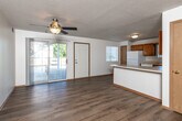 Located at 4001 EP True Pkwy in West Des Moines, Iowa, this single-floor, 2-bedroom, 2-bathroom residence offers a practical and comfortable layout with a clean, neutral aesthetic throughout. Light wood-style flooring runs continuously across the unit, complementing the white walls and warm wood trim that frame each room.

The open-concept kitchen and living area serves as the heart of the home. The kitchen is well-equipped with abundant warm oak cabinetry, white appliances including a refrigerator, electric range, microwave, and dishwasher, as well as a peninsula that provides additional counter space and a natural division from the living area. A window above the sink brings in natural light.

Both bedrooms are comfortably sized, with the primary bedroom offering generous proportions. Each bedroom features ceiling fans, large windows that invite natural light and outdoor views, and ample closet space — one bedroom includes mirrored sliding closet doors. The unit is exceptionally well-appointed with five closets in total, ensuring abundant storage throughout.

The two bathrooms are finished with warm wood vanities and light countertops. One bathroom features a full tub/shower combo. A dedicated in-unit laundry area with a full-size washer and dryer adds everyday convenience, while a separate utility room completes the thoughtful floor plan.