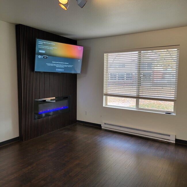 Relax in front of your electric fireplace while enjoying your favorite show on the big screen TV. - 145 5th St W