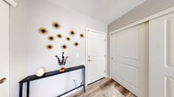 Located in Commerce City, CO, this thoughtfully designed three-story home offers five bedrooms, three full bathrooms, and a layout that maximizes every square foot across its three levels. The entry level provides a welcoming transition into the main living spaces above.

The heart of the home is the open-concept kitchen, dining, and living area on the main floor. The kitchen features dark shaker-style cabinetry, granite countertops, stainless steel appliances, and a large island with bar seating and a built-in sink — ideal for both cooking and casual dining. Pendant lighting illuminates the island, while recessed ceiling lights and light hardwood flooring enhance the bright, airy feel. The adjacent living room offers generous natural light through large windows with views of the surrounding area. A dedicated dining room with hardwood flooring and a window provides a comfortable space for formal meals.

The upper floors house all five bedrooms, each with carpet flooring and natural light from well-placed windows. Bedrooms include closet space, and the spacious primary suite offers a generous footprint. The three bathrooms are finished with granite-topped vanities, dark cabinetry, and tile flooring. One bathroom features a walk-in shower with glass doors. The home's clean, neutral palette and modern finishes create a cohesive and move-in-ready atmosphere throughout.