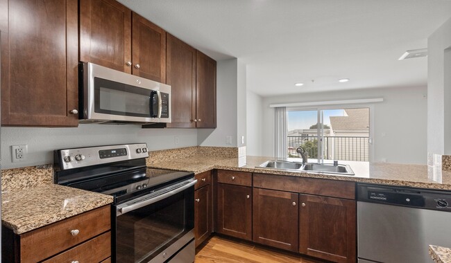 Kitchens feature granite countertops and offer a separate dining area to enjoy your meals - Pacific Bay Vistas Apartments