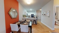 Located at 4830 Wescott Blvd in Summerville, South Carolina, this single-floor residence offers a thoughtfully designed layout with modern finishes throughout. The entryway provides a welcoming introduction, featuring warm-toned hardwood-style flooring that extends throughout much of the home.

The kitchen is a standout feature, showcasing a two-tone cabinet design with crisp white upper cabinetry and slate-blue lower cabinets, complemented by light countertops. A peninsula with bar seating offers casual dining space, while black appliances — including a full-size refrigerator, range, microwave, and dishwasher — add a bold contrast. The kitchen opens directly to the living area, creating a seamless flow ideal for entertaining.

The living room is bright and inviting, with a ceiling fan, large windows, and a glass door that allows natural light to fill the space. The bedrooms are comfortably sized with plush carpeting, ample natural light from well-placed windows, and room for full furniture arrangements. 

The bathrooms feature white shaker-style vanities with large mirrors, tub-shower combinations, and hardwood-style flooring. A dedicated in-unit laundry area houses a full-size washer and dryer, adding everyday convenience. Neutral wall tones throughout give the space a clean, versatile aesthetic.