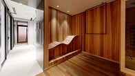Located at 1114 Rue Saint-Antoine Ouest in Montréal, this dedicated wellness facility offers a thoughtfully curated spa experience across a single, well-appointed floor. The space is designed with a cohesive natural aesthetic, making extensive use of warm cedar wood paneling, hardwood flooring, and refined finishes throughout.

Guests are welcomed through hallways that set a calm, transitional tone before arriving at the suite's key amenities. A striking salt sauna features backlit Himalayan salt brick walls that cast a warm amber glow, paired with tiered cedar benches — creating an immersive therapeutic environment. Adjacent to it, an infrared sauna encased in light wood with glass panel doors offers a modern and private heat therapy experience.

A cedar-lined relaxation room with an ergonomic wave lounger provides a tranquil space to rest between treatments. The chromatherapy shower, marked with a branded sign, features sleek light-toned tile walls and a glass enclosure accented by vibrant tropical botanical imagery, adding a refreshing visual element.

Recessed lighting throughout ensures a soft, spa-like ambiance, while the careful integration of natural materials fosters a sense of warmth and well-being. This wellness suite delivers a complete, high-end retreat experience in the heart of Montréal.