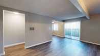Located at 6700 Telephone Rd in Ventura, California, this single-floor residence offers a well-organized layout designed for comfortable everyday living. The main living area features smooth wood-style flooring that reflects natural light, neutral gray walls, a textured ceiling, and a ceiling fan for year-round comfort. A sliding glass door with vertical blinds opens to an outdoor area, filling the space with abundant natural light and providing easy access to the exterior.

The galley-style kitchen is efficiently designed with white shaker cabinetry, granite-style countertops, a stainless steel gas range, built-in microwave, dishwasher, and hardwood-style flooring — delivering both functionality and a clean, modern aesthetic. A window above the counter allows natural light to brighten the workspace.

The bedrooms are carpeted with neutral tones, offering a soft and comfortable atmosphere. Each room benefits from windows fitted with vertical blinds that allow for adjustable light control. An additional room with wood-style flooring and a ceiling fan provides flexible use as a dining area or secondary living space.

The bathroom is finished with a white shaker vanity, granite-style countertop, an oval undermount sink with oil-rubbed bronze fixtures, a mirrored medicine cabinet, and a full-size soaking tub with shower combination — providing a clean, functional design throughout.