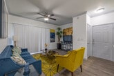 Located at 11111 Grant Rd in Cypress, TX, this single-floor residence offers a thoughtfully designed layout with modern finishes and a clean, contemporary aesthetic throughout. The open living area is anchored by wood-look flooring, crown molding, and a ceiling fan, while a sliding glass door floods the space with natural light and opens to a private balcony overlooking lush greenery. The kitchen is well-equipped with gray shaker-style cabinetry, white quartz countertops, a mosaic tile backsplash, stainless steel appliances, and a deep single-basin sink, with a pass-through opening that connects to the main living area. Each bedroom features plush carpet flooring, ceiling fans, and large windows with blinds that allow for ample natural light. The bathrooms are finished with gray vanity cabinetry, white quartz countertops, large framed mirrors, and wood-look tile flooring, with one bathroom offering a soaking tub and shower combination. A dedicated laundry room houses a full-size side-by-side washer and dryer with overhead shelving for added storage. The overall ambiance of the space is bright, clean, and modern, making it a comfortable and functional place to call home.