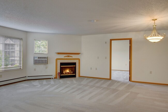 Heritage Park Living Room with Beautiful Fireplace in Select Units - Heritage Park Apartment Homes