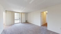 Located at 108 Summit Pointe Dr in Scranton, Pennsylvania, this single-floor residence offers four bedrooms and two bathrooms across a well-organized layout. The living area is broad and open, featuring neutral carpet, bright white walls, and a sliding glass door with vertical blinds that leads to a private balcony with outdoor views. A dedicated dining room sits adjacent, providing a clear flow for everyday living and entertaining. The galley-style kitchen is efficiently designed with warm honey-toned wood cabinetry lining both walls, white countertops, wood-look flooring, and a full suite of white appliances including a gas range, dishwasher, and refrigerator — with additional pantry storage at the end of the galley. The four bedrooms are carpeted and filled with natural light from windows with blinds; the primary bedroom is notably spacious. One bedroom features an elegant chandelier fixture, adding a distinctive touch. The two bathrooms offer different configurations — one includes a walk-in shower with a sliding glass door and tile surround, while the other features a soaking tub, a wide vanity with under-sink storage, and a well-lit mirror. Seven closets throughout the residence provide exceptional storage capacity, complemented by connecting hallways that ensure a practical and comfortable flow throughout the home.