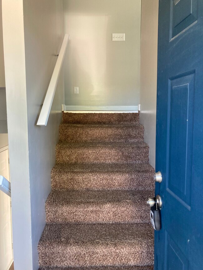 Front door entrance to stairs leading upstairs. - 1080 Fairlane Ct