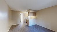 Located at 5111 N Mesa St in El Paso, Texas, this efficiently designed single-floor unit offers a practical and functional layout. The open living area features light-toned hardwood-style flooring that extends throughout the space, creating a cohesive and clean aesthetic. Neutral beige walls and white ceilings contribute to a bright, airy atmosphere.

The kitchen is defined by a half-wall breakfast bar that separates it from the living area, offering light wood cabinetry, a white range, and a sink with under-counter storage. This open-concept arrangement allows natural sightlines across the main living space.

The living area is open and versatile, bathed in natural light from a large window near the entry door, which also allows views of the exterior. A wall-mounted HVAC unit provides climate control.

The unit includes two bathrooms, one of which features a soaking tub with full white tile surround and a window above that lets in natural light. A dedicated closet with a hanging rod provides useful storage space. The overall design is clean, simple, and move-in ready, offering a straightforward and practical living environment in the heart of El Paso.