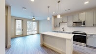 Located at 257 Indian Lake Blvd in Hendersonville, TN, this well-appointed one-bedroom, one-bathroom residence offers a thoughtfully designed open-concept layout. The combined kitchen and living area serves as the heart of the home, where wood-look flooring, neutral tones, and abundant natural light from large windows and a glass balcony door create a bright, welcoming atmosphere. A ceiling fan adds comfort to the living space, which opens directly to a private balcony with outdoor views.

The kitchen is a standout feature, showcasing grey shaker-style cabinetry, a white subway tile backsplash, sleek white quartz countertops, a matte black faucet, and a full suite of stainless steel appliances. A kitchen island with pendant lighting provides additional prep space and a casual dining area.

The generously sized bedroom is finished with plush carpet, a ceiling fan, and a window that fills the room with natural light. It connects directly to a full bathroom appointed with a white quartz vanity, grey cabinetry, matte black fixtures, and a large mirror. A dedicated walk-in closet with wire shelving systems and an in-unit stacked washer and dryer adds exceptional everyday convenience.