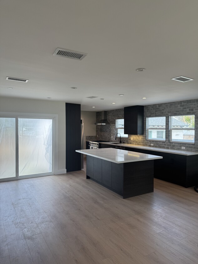 Kitchen island and living room space - 22919 Leonora Dr