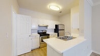 This two-story, one-bedroom, two-bathroom home at 4807 Pin Oak Park in Houston, TX offers a well-organized layout spread across two floors. Light wood-look flooring flows consistently throughout, creating a cohesive and clean aesthetic. The main floor houses the kitchen and living area, while the upper floor is dedicated to the private bedroom suite.

The kitchen is a functional galley-style space featuring crisp white cabinetry, light stone-look countertops, stainless steel appliances including an electric range, dishwasher, and refrigerator, as well as a peninsula with a built-in sink — ideal for casual dining or additional prep space.

The living room is bright and open, with crown molding along the ceiling, a ceiling fan with light fixture, and a window that allows natural light to fill the room.

Upstairs, the generously sized primary bedroom is a serene retreat featuring crown molding, a ceiling fan, and a large window with natural light. It connects to a spacious walk-in closet outfitted with wire shelving on multiple walls, offering ample storage. Two full bathrooms serve the home, one of which includes a full tub-shower combination. The clean, neutral palette throughout gives the space a bright, move-in-ready feel.