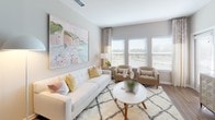 This well-appointed single-floor residence in Myrtle Beach, South Carolina, combines modern design with a coastal-inspired aesthetic. The open-concept layout connects key living areas seamlessly, creating an inviting and functional flow throughout the home.

The kitchen is a standout feature, equipped with dark espresso cabinetry, stainless steel appliances, a subway tile backsplash, and a generous granite-topped island with an undermount sink and bar seating. Pendant lighting and wood-look flooring add warmth and polish to the space.

The living room offers a bright, airy atmosphere, with large windows dressed in blinds and sheer draping that allow ample natural light. Neutral tones and tasteful coastal artwork establish a relaxed yet refined ambiance.

Multiple bedrooms are carpeted and well-lit by large windows with outdoor views. Each room provides comfortable proportions and a calm, neutral palette. The primary bedroom includes a ceiling fan and dedicated sitting area.

Bathrooms are finished with dark vanity cabinetry, granite countertops, and wood-look vinyl flooring, with the primary bath offering access to a walk-in closet. Throughout the residence, consistent use of neutral tones, quality materials, and thoughtful lighting creates a cohesive and comfortable living environment.