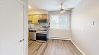 Located at 240 E County Line Rd in Hatboro, PA, this one-bedroom, one-bathroom unit is thoughtfully laid out across a single floor, offering a practical and comfortable living arrangement. The floor plan connects a kitchen, bedroom, bathroom, and hallway in a compact yet functional layout.

The kitchen is a standout feature, equipped with stainless steel appliances including a refrigerator, range, microwave, and dishwasher. Warm honey-toned wood cabinetry pairs with granite countertops and a stainless sink, all set atop durable hardwood-style flooring. A ceiling fan and window allow for natural light and ventilation in the adjoining dining or living area.

The spacious bedroom is carpeted for comfort and includes a closet with a paneled door. A window brings in natural light, while a baseboard heating unit and wall-mounted air conditioner provide year-round climate control. The neutral gray walls create a clean, versatile backdrop.

The bathroom features a full tub-shower combination with floor-to-ceiling large-format gray tile on the surround and a handheld showerhead, offering a clean, modern aesthetic. Throughout the unit, neutral tones, white trim, and consistent finishes contribute to a cohesive and move-in-ready atmosphere.