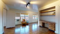 Located at 630 E. Town St. in Columbus, Ohio, this single-floor unit offers a practical and comfortable layout with a range of classic architectural details. The main living area is bright and open, featuring rich hardwood floors that extend throughout the space. Multiple windows allow natural light to fill the room, offering views of the surrounding neighborhood. A standout feature is the built-in desk and shelving unit, providing a dedicated workspace neatly integrated into the living area. Track lighting overhead adds a modern touch to the otherwise classic aesthetic.

The bedroom is a well-proportioned, quiet room with the same warm hardwood flooring and a large window that brings in additional natural light. It connects conveniently to the rest of the unit and sits adjacent to a full bathroom.

The bathroom retains a vintage character, showcasing classic white square tile wainscoting with a black accent border, a pedestal sink, and a mirrored medicine cabinet — details that reflect the building's period architecture.

The galley-style kitchen is efficiently designed with white cabinetry, ample counter space, a gas range, and a refrigerator. Stone-look tile flooring completes the practical, clean aesthetic of the kitchen. Overall, the unit blends vintage charm with functional living in a convenient Columbus location.
