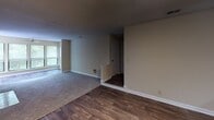 Located at 454 Johnny Mercer Blvd in Savannah, Georgia, this single-floor residence offers a well-organized layout designed for comfortable everyday living. The interior is finished with warm neutral tones throughout, creating a cohesive and welcoming atmosphere across all rooms.

The kitchen is efficiently designed in an L-shaped configuration, featuring ample upper and lower cabinetry with wood-trimmed accents, a double-basin stainless steel sink, a full-size refrigerator, and a white electric range with overhead ventilation. Durable hardwood-style flooring runs through the kitchen and extends into the adjacent living area, which benefits from natural light streaming through large windows fitted with blinds.

The bedrooms are carpeted for comfort and each offer generous wall space. One bedroom includes a bi-fold closet with built-in shelving and hanging rods, providing practical storage solutions. Additional closet space is available throughout the unit.

The residence includes two bathrooms, each equipped with a full tub-and-shower combination. One bathroom features hardwood-style flooring, while both maintain the home's consistent neutral color palette. A dedicated utility or storage area adds further functionality to the layout.

Overall, this Savannah residence presents a practical and move-in-ready living environment with a clean, understated design suited for a range of lifestyles.