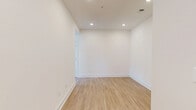 Located at 2219 Jack Ln in Bel Air, Maryland, this two-story home offers 2 bedrooms, 2 bathrooms, and a versatile loft space across a well-designed floor plan. The main level features an open-concept kitchen and living room with light hardwood-style flooring, soaring ceilings, and a fireplace in the living area. Large windows invite abundant natural light and outdoor views of surrounding greenery. The kitchen is appointed with white shaker cabinetry, stainless steel appliances including a gas range, microwave, and French door refrigerator, and a generous island with a white quartz countertop and undermount sink. The primary bedroom is notably spacious, featuring plush carpet, a ceiling fan, and multiple windows with tree-lined views. The second bedroom also offers carpeted floors, a ceiling fan, and natural light. Both bathrooms are finished with large-format tile flooring, white vanities with quartz countertops, gold-toned fixtures, and backlit mirrors. One bathroom includes a glass-enclosed shower. The upper loft area features carpet and an open railing overlooking the staircase. Additional highlights include five closets, four hallways, and a dedicated laundry room, offering ample storage and convenience throughout.