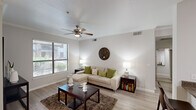 This single-story residence offers a thoughtfully designed layout across two bedrooms and two bathrooms. The combined living and dining area forms the heart of the home, featuring light wood-style flooring, crown molding, and a ceiling fan with light fixture. A large window allows natural light to fill the living space, creating a bright and welcoming atmosphere. The dining area connects seamlessly to the living room and is positioned adjacent to the kitchen, making the space ideal for everyday living and entertaining.

The kitchen is equipped with warm-toned wood cabinetry extending to the ceiling for ample storage, granite-style countertops, and black appliances including a dishwasher and range.

The primary bedroom features a tray ceiling, ceiling fan, a window with outdoor views, and generous closet space with wire shelving systems. The second bedroom is comparably comfortable, also including a ceiling fan and ample natural light. Both bedrooms are served by well-appointed bathrooms, one of which features a full tub and shower combination, wood-style tile flooring, an extended vanity with under-cabinet storage, and white cabinetry above.

Hallways connect the bedrooms efficiently to the main living areas, and two closets provide practical storage throughout the residence.
