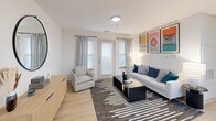 Located at 5005 Community Circle in Charlotte, NC, this 2-bedroom, 2-bathroom single-floor residence offers a thoughtfully designed layout that maximizes comfort and functionality. Light wood-tone flooring flows continuously throughout, complementing the clean white walls and creating a bright, cohesive aesthetic.

The open-concept living, dining, and kitchen area forms the heart of the home. The living room features large windows and a glass door that flood the space with natural light, while the kitchen stands out with white upper cabinetry, two-toned grey lower cabinets, quartz countertops, stainless steel appliances, and a central island with bar seating — ideal for both meal prep and casual dining.

A central hallway connects the bedrooms and bathrooms, offering a clear and efficient flow. The primary bedroom is a comfortable retreat with a glass door to the exterior, generous natural light, and ample closet space. The second bedroom is equally well-appointed. Both bathrooms feature grey shaker-style vanities with white quartz countertops, modern light fixtures, and large mirrors, reflecting a consistent and polished design language.

With four closets distributed throughout, storage is plentiful. The overall ambiance is modern, clean, and welcoming, making this Charlotte residence a practical and stylish place to call home.
