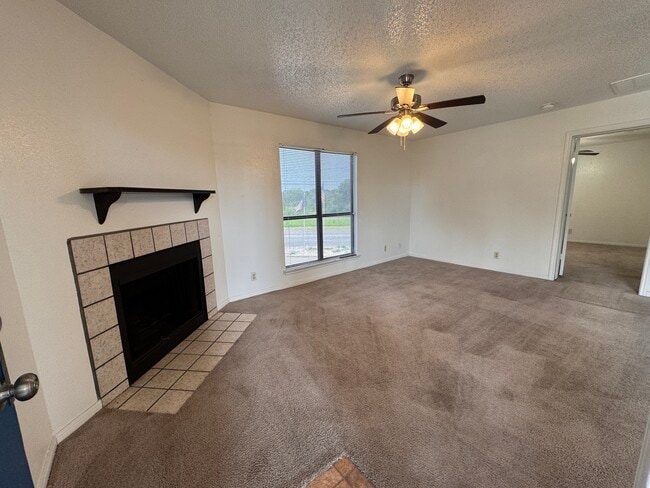 Spacious living room and cozy fireplace - Cedar Station Apartments