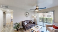 Located in Mesa, Arizona, this 2-bedroom, 2-bathroom single-floor residence offers a thoughtfully arranged layout with modern finishes and comfortable living spaces. The living room serves as the heart of the home, showcasing wood-look flooring, a ceiling fan with light fixture, and a white-surround fireplace that adds a classic focal point. A sliding glass door with vertical blinds fills the space with natural light and provides views of the surrounding greenery outside.

The kitchen features a galley-style design with white cabinetry, white countertops, and a full suite of stainless steel appliances, including a refrigerator, range, and over-the-range microwave — offering both efficiency and a clean aesthetic.

Each bedroom is equipped with its own ceiling fan and wood-look flooring. The primary bedroom includes access to a dedicated closet, while a second closet provides additional storage. The second bedroom also features a window that brings in natural light.

Both bathrooms are finished with white vanities, large mirrors with overhead lighting, and tub/shower combinations. The primary bath is conveniently positioned adjacent to a walk-in closet with built-in shelving and hanging space. A connecting hallway ties all rooms together for a cohesive, efficient flow throughout the home.
