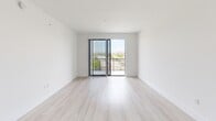 Located at 101 W Camino Real in Boca Raton, FL, this modern one-bedroom, one-bathroom unit offers a well-designed, efficient layout across a single floor. Light wood-tone flooring flows consistently throughout the space, contributing to a clean and cohesive aesthetic.

The open-concept kitchen and living area serves as the heart of the unit. The kitchen features sleek, light-toned cabinetry extending to the ceiling, white quartz countertops, a stainless steel sink, and a full suite of stainless steel appliances including a refrigerator with ice and water dispenser, electric range, over-the-range microwave, and dishwasher. In-unit washer and dryer are also included. The living area is bright and airy, with a sliding glass door that opens to a private balcony offering outdoor views of the surrounding Boca Raton landscape.

The bedroom is a comfortable, well-proportioned room with a ceiling fan, a window with views to the outside, and access to a dedicated closet outfitted with wire shelving for organized storage.

The bathroom is finished with a white vanity, quartz countertop, large mirror, and a full tub-shower combination framed in large-format neutral tile. A hallway connects all areas of the unit cohesively. The overall ambiance is clean, modern, and move-in ready.