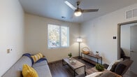 Located in Memphis, TN, this single-story residence features four bedrooms and four full bathrooms, delivering a well-designed layout suited for shared or family living. The interior is finished with durable wood-style flooring throughout, neutral walls, and contemporary fixtures that create a clean, cohesive aesthetic.

The living area is bright and welcoming, featuring a ceiling fan with light, a large window with outdoor views of surrounding greenery, and ample space for comfortable seating arrangements. Adjacent to the living area, the kitchen is a standout feature, boasting dark cabinetry, stainless steel appliances including a refrigerator, microwave, and range, along with a granite-topped peninsula with bar seating and pendant lighting overhead — ideal for casual dining and entertaining.

Each of the four bedrooms offers its own character, with large windows that invite natural light and outdoor views. Select rooms feature sliding closets for storage. The four bathrooms are uniformly appointed with granite-topped vanities, dark cabinetry, and full tub-shower combinations, providing each resident with private, well-equipped facilities.

Throughout the home, the design emphasizes practicality and comfort, with consistent finishes and a bright, airy atmosphere that makes this Memphis residence a well-rounded living option.