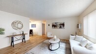 This single-floor, 2-bedroom, 2-bathroom home in Santee, California offers a thoughtfully organized layout that maximizes functionality across its living spaces. The bright living room features light wood-style flooring, a textured ceiling, and a large window with vertical blinds that invites natural light into the space. The adjacent dining area continues the warm flooring, accented by a ceiling fan and a window overlooking the outdoors, creating a welcoming atmosphere for gatherings. The kitchen is well-appointed with rich wood cabinetry, granite countertops, stainless steel appliances including a refrigerator, range, and microwave, plus a breakfast bar ideal for casual dining. Both bedrooms are comfortably sized and carpeted, offering a cozy retreat. The primary bedroom features a closet with sliding doors, while the second bedroom serves flexibly as an office. The two bathrooms are finished with granite-topped vanities, wood cabinetry, and light flooring; one includes a tub-shower combo with sliding glass doors and a window for natural ventilation. Throughout the home, a neutral, light color palette creates a clean, cohesive ambiance suited for comfortable everyday living.