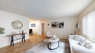 This single-floor, 2-bedroom, 2-bathroom home in Santee, California offers a thoughtfully organized layout that maximizes functionality across its living spaces. The bright living room features light wood-style flooring, a textured ceiling, and a large window with vertical blinds that invites natural light into the space. The adjacent dining area continues the warm flooring, accented by a ceiling fan and a window overlooking the outdoors, creating a welcoming atmosphere for gatherings. The kitchen is well-appointed with rich wood cabinetry, granite countertops, stainless steel appliances including a refrigerator, range, and microwave, plus a breakfast bar ideal for casual dining. Both bedrooms are comfortably sized and carpeted, offering a cozy retreat. The primary bedroom features a closet with sliding doors, while the second bedroom serves flexibly as an office. The two bathrooms are finished with granite-topped vanities, wood cabinetry, and light flooring; one includes a tub-shower combo with sliding glass doors and a window for natural ventilation. Throughout the home, a neutral, light color palette creates a clean, cohesive ambiance suited for comfortable everyday living.