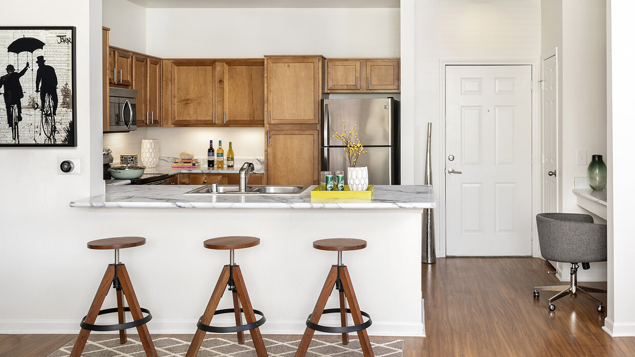 Apartment Kitchen with Stainless Steel Appliances, quartz counters and wood floors. - Griffis Fitzsimons South