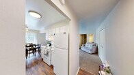 Located at 27435 Greenfield Rd in Southfield, Michigan, this one-bedroom, three-bathroom residence offers a practical and comfortable single-floor layout. The open living area is generously sized, featuring soft wall-to-wall carpeting, neutral tones, and large windows dressed with vertical blinds that allow natural light to fill the space. The living room flows seamlessly into a dining area, creating an inviting environment for everyday living and entertaining.

The galley-style kitchen is efficiently designed with white cabinetry, white appliances including a range and refrigerator, ample counter space, and durable hardwood-style flooring. The layout maximizes functionality while maintaining a clean, bright aesthetic.

The spacious primary bedroom offers plush carpeting, a double-door closet, and a calm, neutral color palette. The three bathrooms are each thoughtfully designed — one features a long vanity with dual mirrors and warm wood flooring in a soft blue palette, while another includes a tiled tub-shower combination with a grab bar and a white vanity with overhead lighting in soft lavender tones.

Two hallways connect the living spaces efficiently, contributing to a smooth and logical flow throughout the home. The overall ambiance is clean, functional, and move-in ready, making this Southfield residence a well-rounded option for comfortable everyday living.