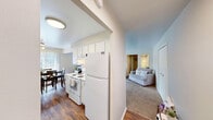 Located at 27435 Greenfield Rd in Southfield, Michigan, this one-bedroom, three-bathroom residence offers a practical and comfortable single-floor layout. The open living area is generously sized, featuring soft wall-to-wall carpeting, neutral tones, and large windows dressed with vertical blinds that allow natural light to fill the space. The living room flows seamlessly into a dining area, creating an inviting environment for everyday living and entertaining.

The galley-style kitchen is efficiently designed with white cabinetry, white appliances including a range and refrigerator, ample counter space, and durable hardwood-style flooring. The layout maximizes functionality while maintaining a clean, bright aesthetic.

The spacious primary bedroom offers plush carpeting, a double-door closet, and a calm, neutral color palette. The three bathrooms are each thoughtfully designed — one features a long vanity with dual mirrors and warm wood flooring in a soft blue palette, while another includes a tiled tub-shower combination with a grab bar and a white vanity with overhead lighting in soft lavender tones.

Two hallways connect the living spaces efficiently, contributing to a smooth and logical flow throughout the home. The overall ambiance is clean, functional, and move-in ready, making this Southfield residence a well-rounded option for comfortable everyday living.