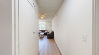 Located at 720 W 27th St in Los Angeles, CA, this 2-bedroom, 2-bathroom unit offers a well-organized single-floor layout with a clean, functional design throughout. The open living and dining area is anchored by large windows that frame views of surrounding greenery, filling the space with abundant natural light. Light wood flooring runs seamlessly through the common areas and bedrooms, contributing to a bright and cohesive aesthetic. The living room provides ample space for both lounging and dining, complemented by a wall-mounted A/C unit for year-round comfort.

The primary bedroom is generously sized, accommodating multiple beds and dedicated desk areas, making it well-suited for shared living or study-focused occupants. Large windows with vertical blinds flood the room with daylight and offer leafy outdoor views. The second bedroom also features light wood floors, a sliding-door closet for storage, and room for multiple sleeping and workspace configurations.

Both bathrooms are finished with modern wood-grain cabinetry, stone-toned countertops, large vanity mirrors, and chrome fixtures. One bathroom includes a shower-tub combination with a sliding frosted glass enclosure. A hallway connects the rooms, ensuring a logical and efficient flow throughout the unit.