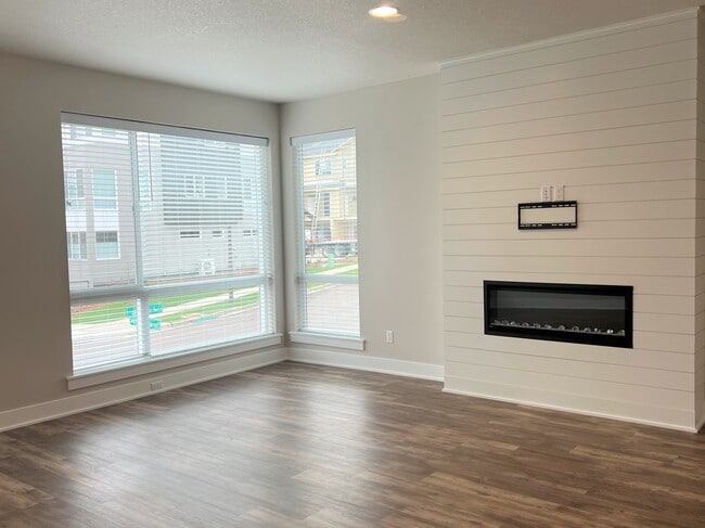 Living Room with Ample Windows and Electric Fireplace - 12428 SW 171st Ter