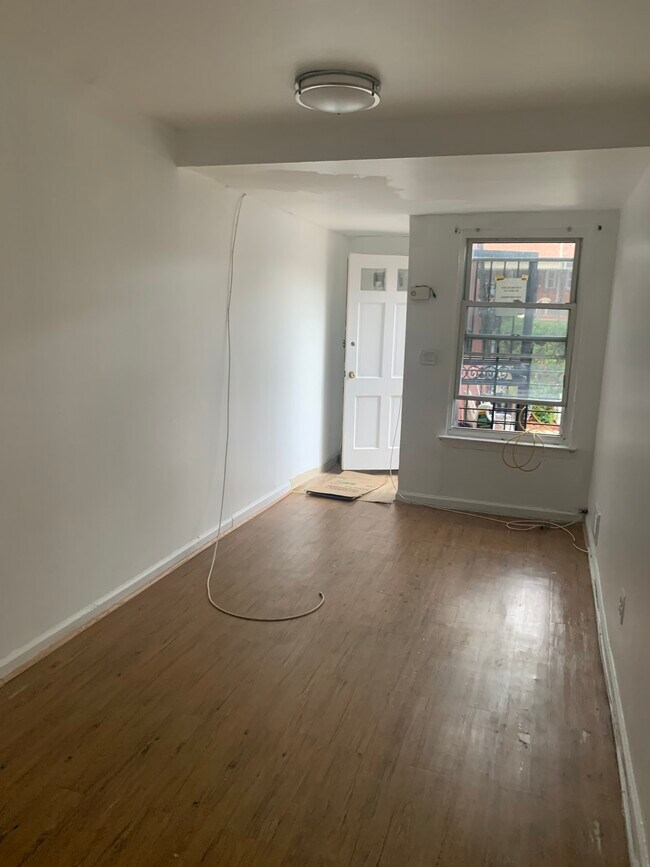 Living room freshly painted with luxury vinyl plank wood flooring - 1156 E 223rd St