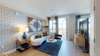 Located in the vibrant North Park neighborhood of San Diego, this single-floor residence at 4499 Ohio St showcases a thoughtfully designed, open-concept layout with contemporary finishes throughout. Light wood flooring flows seamlessly across the living, dining, and kitchen areas, creating a warm and cohesive aesthetic.

The living room is a standout space, anchored by a bold geometric feature wall that adds depth and visual interest. Large windows and a glass door invite abundant natural light and provide elevated views of the San Diego cityscape, offering a bright and airy atmosphere. A cozy balcony nook with oversized windows extends the sense of connection to the outdoors.

The kitchen is well-appointed with light wood cabinetry, quartz countertops, a classic white tile backsplash, stainless steel appliances, and a peninsula island with bar seating. Pendant lighting above the island adds a modern, polished touch. The open sightlines between the kitchen and living area enhance the sense of space and make the layout ideal for entertaining.

The bathroom features a clean, minimalist design with light wood vanity cabinetry, a white countertop, and wood-look flooring that ties seamlessly to the rest of the home. Curated artwork throughout the space reinforces the modern, design-forward character of this San Diego residence.