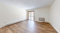 Located at 500 Atlantic Avenue in Leominster, Massachusetts, this two-bedroom, one-bathroom residence offers a well-organized and functional layout across a single floor. Warm wood-style flooring flows throughout the home, creating a cohesive and inviting atmosphere.

The combined kitchen and living area forms the heart of the space. The kitchen is well-appointed with white cabinetry, granite-style countertops, a full suite of white appliances including a range, microwave, refrigerator, and dishwasher, and a double basin sink. A peninsula counter opens toward the living area, facilitating an easy connection between cooking and entertaining spaces. The living room benefits from a wood-framed sliding glass door that leads directly to a private balcony, filling the room with natural light.

Both bedrooms feature wood-style flooring, natural light from multiple windows, and warm-toned wood bifold closet doors. The spacious primary bedroom is particularly well-lit, with two windows. Four closets are distributed throughout the home, providing ample storage.

The bathroom includes a full tub-shower combination with accessibility grab bars and tile flooring. A dedicated laundry area adds everyday convenience. Baseboard heating is present throughout, and a wall air conditioning unit ensures year-round comfort.