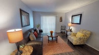Located at 2102 E 51st St in Tulsa, Oklahoma, this single-floor unit offers a well-organized and functional layout across its living, dining, kitchen, bedroom, and bathroom spaces. The living room is a welcoming area featuring dark hardwood-style flooring, a textured ceiling, and a large sliding glass door dressed with vertical blinds that allows ample natural light to filter in. The open and comfortable layout provides generous room for seating and entertaining.

The galley-style kitchen is efficiently designed with dark cabinetry, light speckled countertops, and a full suite of black appliances including an electric range with overhead ventilation, a refrigerator, and ample cabinet storage. The kitchen connects seamlessly to the dining area, which includes a ceiling fan and additional natural light.

The bedroom is a calm and sizeable retreat with the same hardwood-style flooring, a textured ceiling, and a window with blinds providing natural light. A notable feature is the walk-in closet, offering generous storage space.

The full bathroom includes a wide vanity with a speckled countertop, an extended mirror, dark cabinetry, and a tub-shower combination. Throughout the unit, the consistent use of hardwood-style flooring and neutral wall tones creates a cohesive and modern aesthetic.
