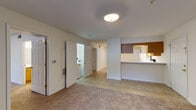 Located at 1110 McKimmon View Ct in Raleigh, NC, this single-floor unit offers a functional and well-organized layout designed for comfortable everyday living. The open living and dining area is finished with warm neutral carpet and tile flooring, and is bathed in natural light through sliding glass doors fitted with vertical blinds that open to an outdoor view. A pass-through counter connects the living space to the kitchen, creating an open and accessible flow between the two areas.

The kitchen is equipped with warm-toned wood cabinetry, white appliances including a refrigerator, electric range, and dishwasher, and a double-basin sink beneath under-cabinet lighting. Tile flooring carries throughout the kitchen, and a dedicated pantry closet provides additional storage. A conveniently located in-unit laundry area is accessible directly from the main living space.

Both bedrooms feature plush carpeting and ample closet space, with one bedroom offering a large window overlooking lush greenery. Each of the two full bathrooms is outfitted with warm wood vanity cabinetry, a white countertop, tile flooring, and a full tub-shower combination, providing a clean and practical design throughout.