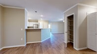 Located at 6444 Eden Garden Dr in Loveland, CO, this well-appointed 2-bedroom, 2-bathroom residence offers a thoughtfully designed single-floor layout. The open-concept living and kitchen area forms the heart of the home, featuring warm hardwood-style flooring that extends throughout. Crown molding adds a refined architectural touch to the main living spaces and primary bedroom.

The kitchen is equipped with stainless steel appliances, granite-look countertops, white cabinetry, and a peninsula with bar seating — ideal for casual dining or entertaining. A built-in pantry with wire shelving provides generous storage just off the kitchen.

The spacious living room is brightened by a ceiling fan and sliding glass door that opens onto a private balcony, offering open views of the surrounding area. The primary bedroom is generously sized and includes crown molding, a ceiling fan, and access to a large walk-in closet outfitted with built-in shelving and hanging rods. The second bedroom also features hardwood-style flooring and a standard closet. Both bathrooms are clean and functional, with one featuring a full soaking tub and shower combination with chrome fixtures. A hallway connects the rooms for a practical and efficient flow throughout the residence.