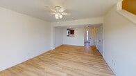 Located at 1104 Sunshine Dr in Culpeper, VA, this two-story home offers 2 bedrooms and 3 bathrooms across two well-proportioned floors. The main level features an open-concept living room and kitchen layout with light hardwood-style flooring throughout. The living room is bright and airy, complete with a ceiling fan and French doors that open to a private outdoor deck, flooding the space with natural light and providing outdoor access. The kitchen is well-appointed with warm wood cabinetry, granite-style countertops, stainless steel appliances including a range, microwave, dishwasher, and refrigerator, plus a double sink beneath a window. A hallway connects the main living areas to the bathrooms, which feature clean white finishes, brushed nickel fixtures, and warm wood vanities. The bedrooms offer light hardwood flooring, ceiling fans, and windows that let in ample natural light, with the primary bedroom providing a comfortable, generously sized retreat. The upper level offers additional living space, maintaining the same clean, neutral aesthetic found throughout. The overall ambiance is bright, clean, and move-in ready, with a consistent modern and functional design throughout both floors.