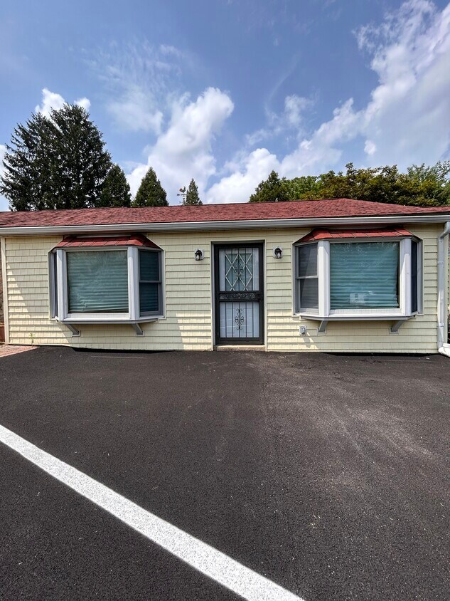 Front door, two bay windows and 2 off street parking spots - 300 Falcon Ln