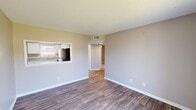 Located in Huntsville, Alabama, this 2-bedroom, 1-bathroom single-floor unit offers a practical and well-appointed layout. The living room is a welcoming space featuring durable wood-look flooring, neutral-toned walls, and a textured ceiling. A pass-through window connects the living area to the kitchen, enhancing the open feel. A sliding glass door floods the room with natural light and provides direct access to a private balcony with outdoor views.

The kitchen is efficiently designed with crisp white shaker-style cabinetry, granite-look countertops, a stainless steel sink with window above, and a full suite of stainless steel appliances including a refrigerator, range, and microwave. Wood-look flooring and a textured ceiling complete the space.

Both bedrooms feature plush carpeting, ceiling fans with light fixtures, and sliding or hinged closet doors offering ample storage. Each room is bright and comfortable, with neutral walls and natural light from windows with blinds.

The bathroom is clean and functional, featuring white tile surround on the tub-shower combo, a granite-top vanity, and a window that introduces natural light. A hallway connects all rooms, creating a cohesive and easy-to-navigate floor plan throughout the unit.