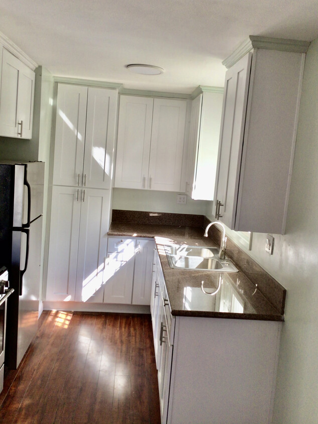 Newly remodeled kitchen with stainless steel appliances and white cabinetry - 7037 W Manchester Ave