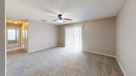Located at 1462 S Colorado St in Greenville, Mississippi, this single-story home offers a practical and comfortable layout across two bedrooms, three bathrooms, and a well-organized set of living spaces. The living room is a bright, open area highlighted by a ceiling fan and a sliding glass door that invites natural light and provides outdoor views. Neutral-toned carpet and clean white baseboards run throughout the carpeted areas, lending a cohesive and tidy aesthetic. The dining room features its own ceiling fan and an elegant chandelier, adding a subtle decorative touch to the space. The kitchen is equipped with white cabinetry accented by wood trim, white countertops, hard surface flooring, and includes a full-size refrigerator and ample storage, including a pantry closet. The primary bedroom offers comfortable proportions, natural light through window blinds, and access to a closet. Additional bedrooms are equally well-lit with ceiling fans and carpeted floors. The three bathrooms are clean and functional, featuring a tub-shower combination and vanity with a wide mirror. Two dedicated closets contribute to the home's practical storage capacity throughout.