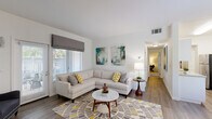 Located at 7300 Parkwood Cir in Dublin, CA, this 2-bedroom, 1-bathroom residence offers a well-designed single-floor layout with a clean, modern aesthetic throughout. The galley-style kitchen is outfitted with white shaker cabinetry, light quartz countertops, a tile backsplash, stainless steel appliances, and wood-look flooring, providing an efficient and stylish workspace. Adjacent to the kitchen, the dedicated dining area features a bright window with garden views, allowing natural light to fill the space. The living room is a welcoming focal point, anchored by a fireplace with a white mantle, wood-look flooring, and a sliding door that opens to an outdoor patio. Both bedrooms are carpeted and feature mirrored sliding closet doors that enhance the sense of space, along with windows that invite natural light. The primary bedroom offers a generous footprint with ample room for full-size furnishings. The bathroom is finished with white cabinetry, quartz countertops, wood-look flooring, and a full shower-tub combination. A hallway connects the main living areas to the private quarters, contributing to a practical and comfortable flow throughout the home.