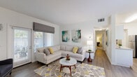 Located at 7300 Parkwood Cir in Dublin, CA, this 2-bedroom, 1-bathroom residence offers a well-designed single-floor layout with a clean, modern aesthetic throughout. The galley-style kitchen is outfitted with white shaker cabinetry, light quartz countertops, a tile backsplash, stainless steel appliances, and wood-look flooring, providing an efficient and stylish workspace. Adjacent to the kitchen, the dedicated dining area features a bright window with garden views, allowing natural light to fill the space. The living room is a welcoming focal point, anchored by a fireplace with a white mantle, wood-look flooring, and a sliding door that opens to an outdoor patio. Both bedrooms are carpeted and feature mirrored sliding closet doors that enhance the sense of space, along with windows that invite natural light. The primary bedroom offers a generous footprint with ample room for full-size furnishings. The bathroom is finished with white cabinetry, quartz countertops, wood-look flooring, and a full shower-tub combination. A hallway connects the main living areas to the private quarters, contributing to a practical and comfortable flow throughout the home.