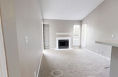 Located at 100 Hickory Highlands Dr in Antioch, TN, this 870-square-foot, single-story apartment offers 3 bedrooms and 2 bathrooms across a well-organized floor plan. The living room is a standout feature, highlighted by a tile-surround fireplace with a white mantel, built-in shelving, wood-look luxury vinyl plank flooring, and large windows that allow abundant natural light and outdoor views of surrounding greenery. The open kitchen connects seamlessly to the living area and features a peninsula island, white cabinetry, stainless steel appliances, and matching LVP flooring. Both bathrooms are finished with white vanities, marble-look countertops, and tub/shower combinations with white tile surrounds. The primary bedroom spans 170 square feet and includes a dedicated walk-in closet with wire shelving and a ceiling fan. Additional bedrooms are carpeted and equipped with ceiling fans; one features a window with natural views. A dedicated laundry room provides added convenience with space for a full-size washer. Neutral gray walls and white trim are consistent throughout, creating a clean and cohesive aesthetic across the entire unit.
