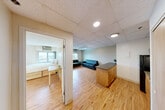 Located at 536 S University Ave in Ann Arbor, MI, this one-bedroom, one-bathroom unit offers a practical and well-organized layout across a single floor. Light hardwood-style flooring runs throughout the main areas, providing a clean and cohesive look.

The combined living and dining room is a generous, open space featuring a drop tile ceiling with recessed and track lighting. The living area accommodates ample seating and includes windows that let in natural light with views of the surrounding cityscape.

The kitchen is efficiently designed with light wood cabinetry, granite-style countertops, a double-basin sink, electric range, and a full-size black refrigerator — providing all essential cooking amenities.

The spacious primary bedroom is notably large, featuring multiple windows that frame elevated city views and fill the room with natural light. Two sets of full-length mirrored sliding closet doors with built-in vanity lighting offer generous storage and add brightness to the space.

The bathroom includes a sliding glass shower enclosure and tile flooring. Two additional closets provide further storage throughout the unit.

This well-situated property places residents within close proximity to the University of Michigan campus and the shops, dining, and amenities of downtown Ann Arbor.
